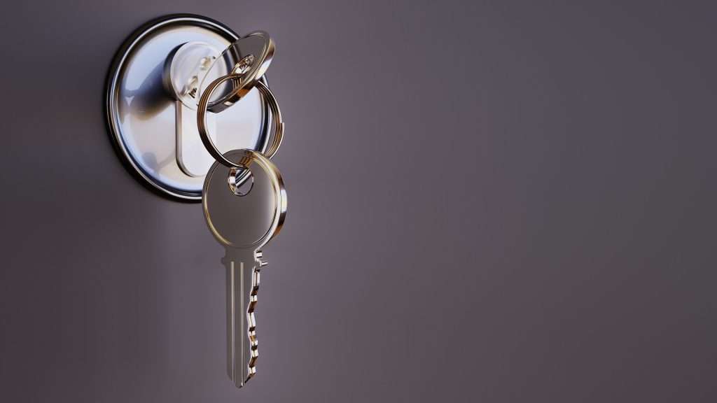 A close-up of a silver house key inserted into a round, silver door lock, symbolizing the absence of an "access clause" often implied in commercial leases. The key has a key ring attached, holding several smaller metal rings that reflect light against a plain, dark background.