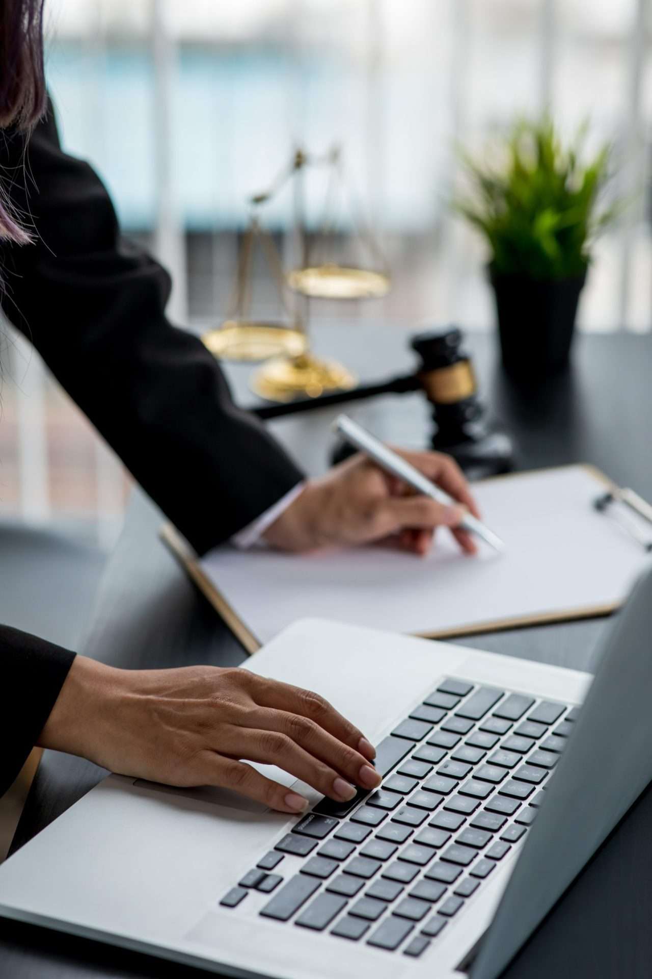 a legal professional does paperwork whilst reading documents.