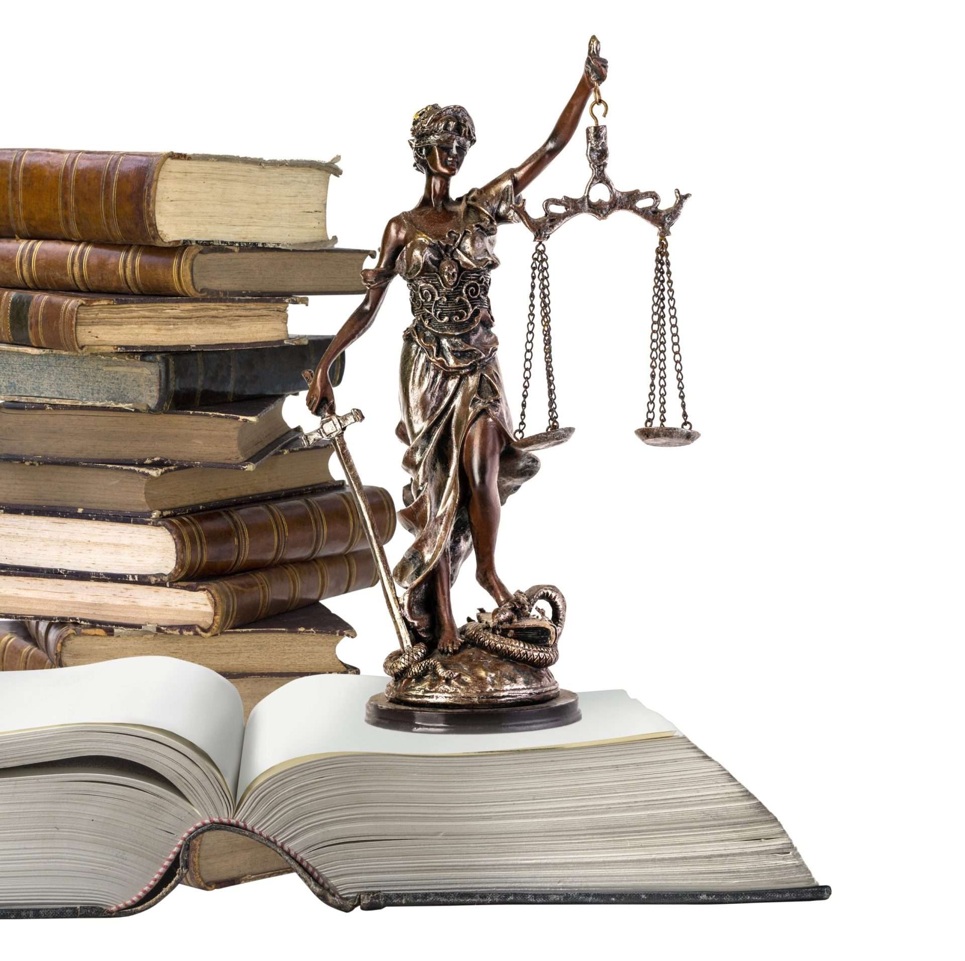 A statue of Lady Justice holding scales stands on an open book, with several closed books stacked in the background. The image symbolizes law and justice, with Lady Justice representing fairness and impartiality.