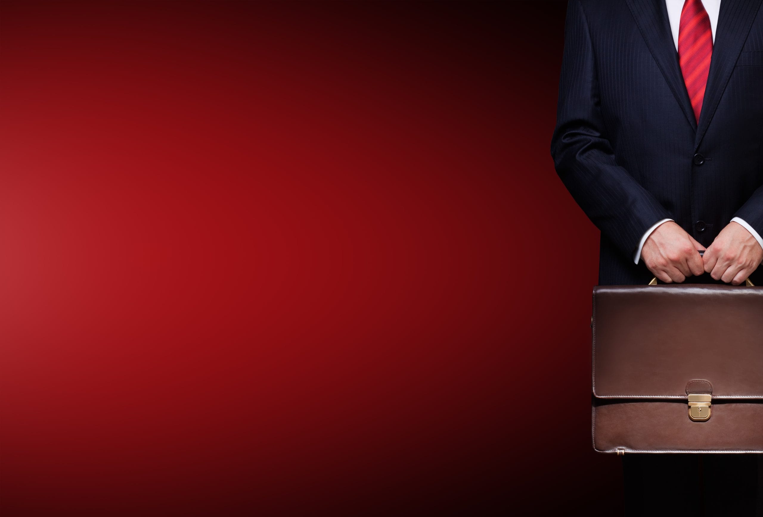 A dispute resolution professional holds a briefcase.